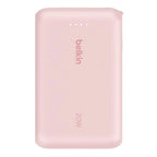 Pink Belkin 10,000 mAh 20W power bank with USB-C port and integrated cable, compact and portable for on-the-go charging.