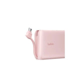Pink Belkin 10,000 mAh 20W Power Bank with USB-C port and integrated cable, designed for portable device charging.